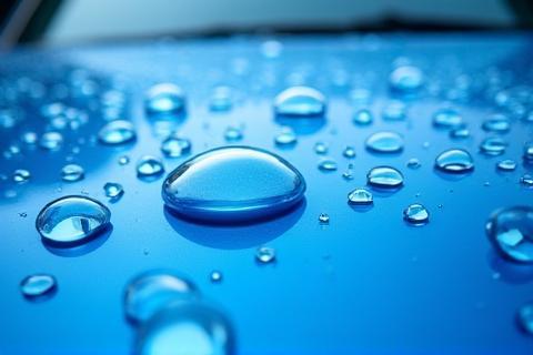 Photo of a blue car showing water beading after ceramic coating