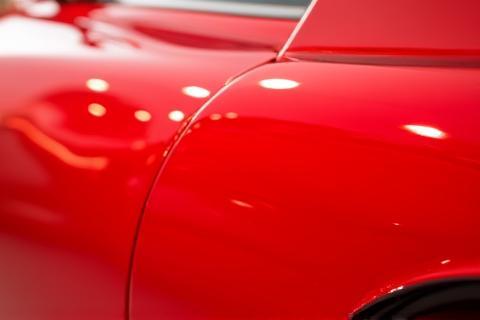 Photo of a red car with a high gloss finish after detailing